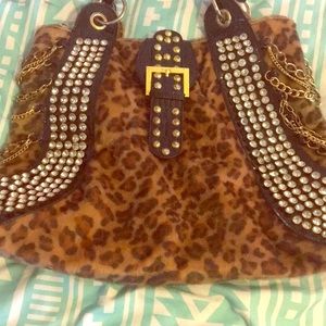 Leopard purse with gold bangles and a lot of bling